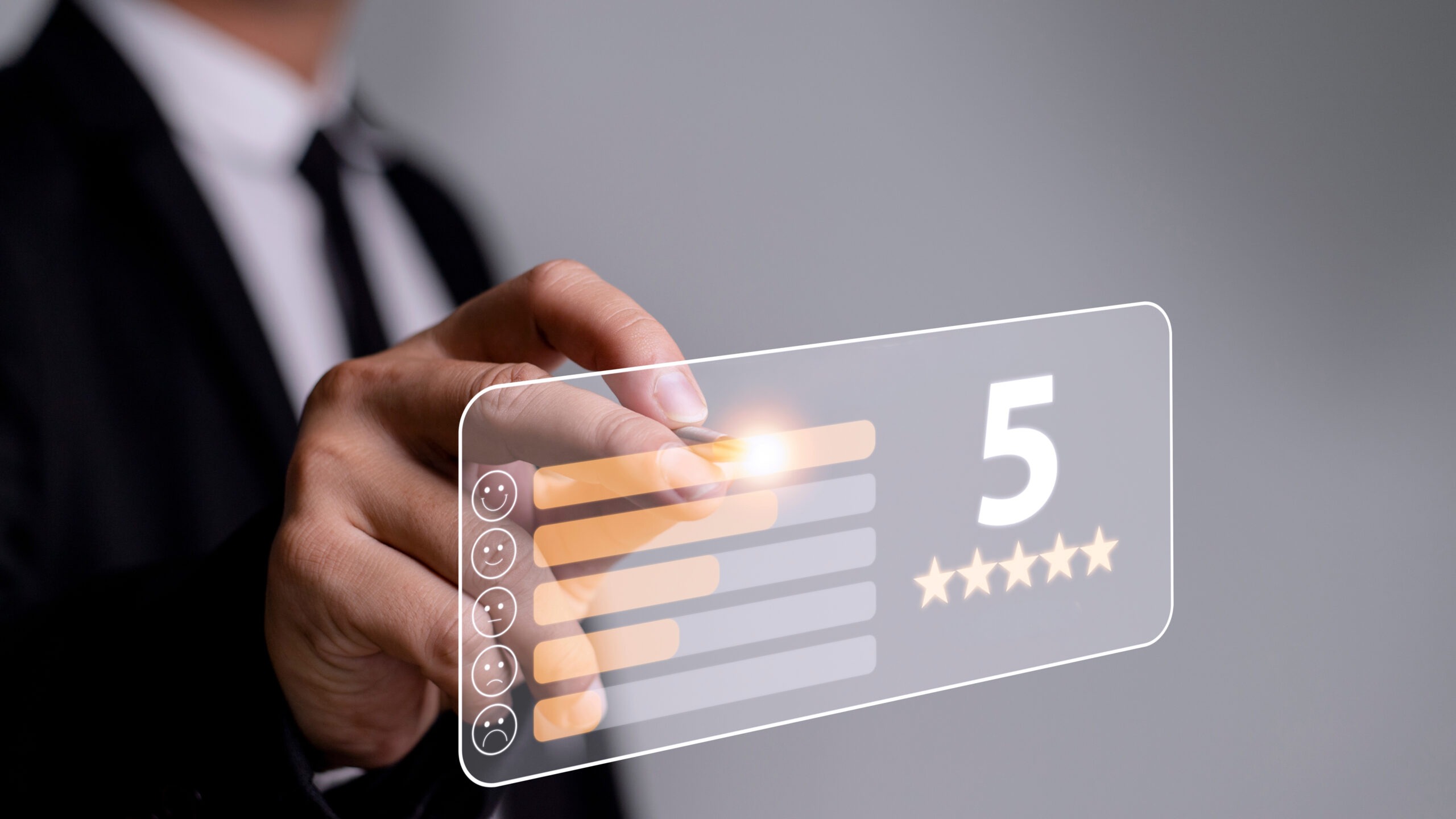 A business professional interacts with a digital interface displaying a five-star rating, emphasizing customer feedback and satisfaction.